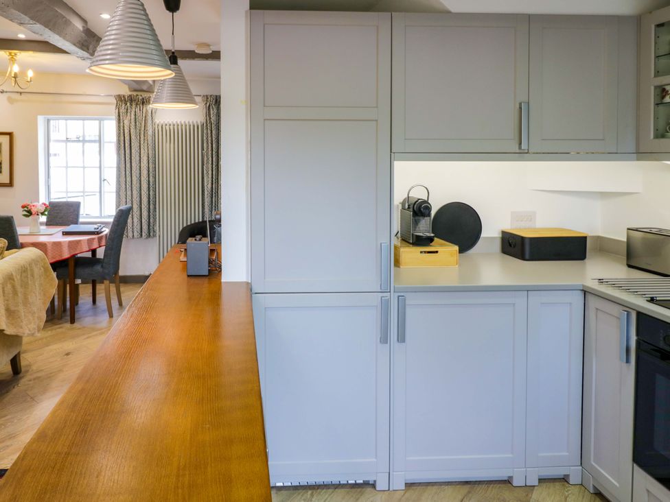 A kitchen with cabinets and a coffee machine at Middle Cottage in Ludlow