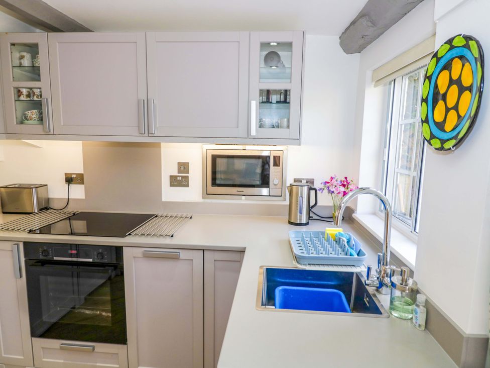 A kitchen with modern appliances and a sink at Middle Cottage in Ludlow