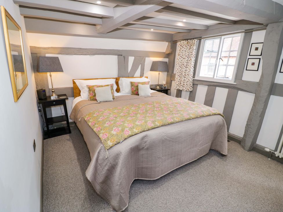 A bedroom with a bed and side tables at Middle Cottage in Ludlow