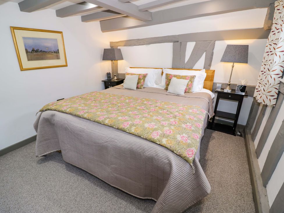 A bedroom with a bed and nightstands at Middle Cottage in Ludlow
