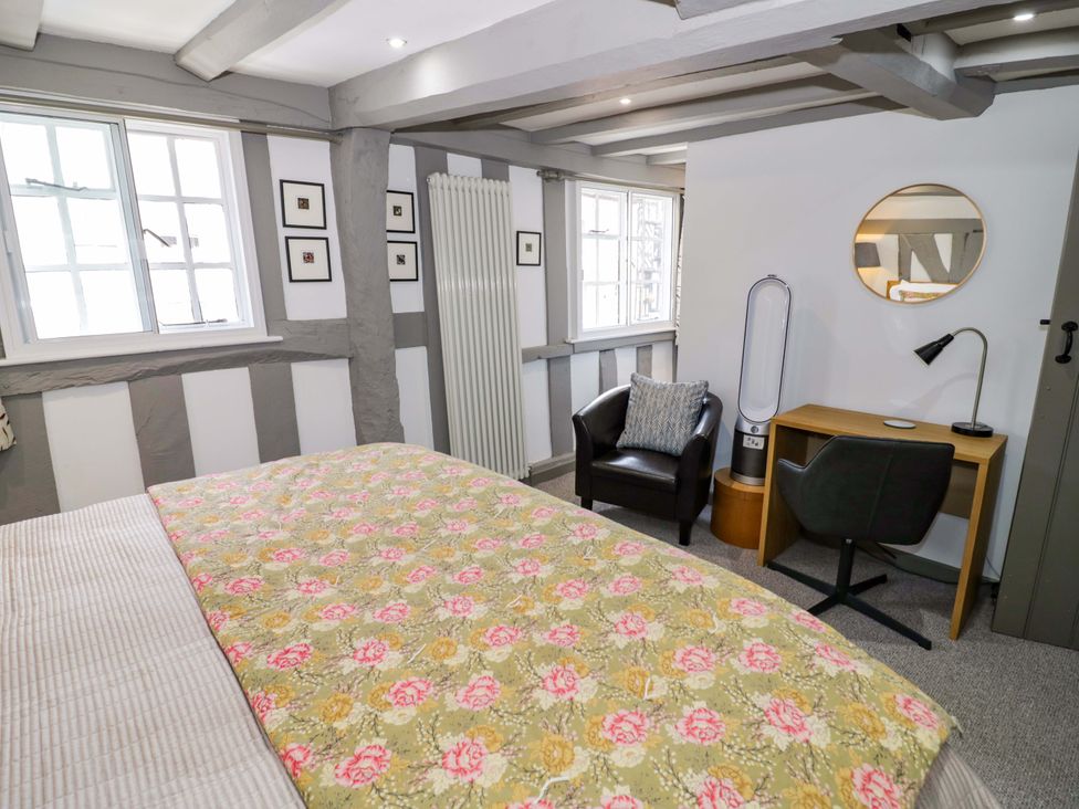 A bedroom with a bed and desk at Middle Cottage in Ludlow