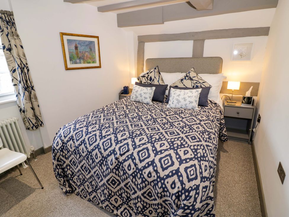 A bedroom with a bed and bedside table at Middle Cottage in Ludlow