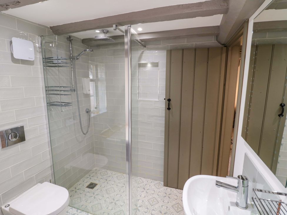 A bathroom with a shower, toilet, and sink at Middle Cottage in Ludlow