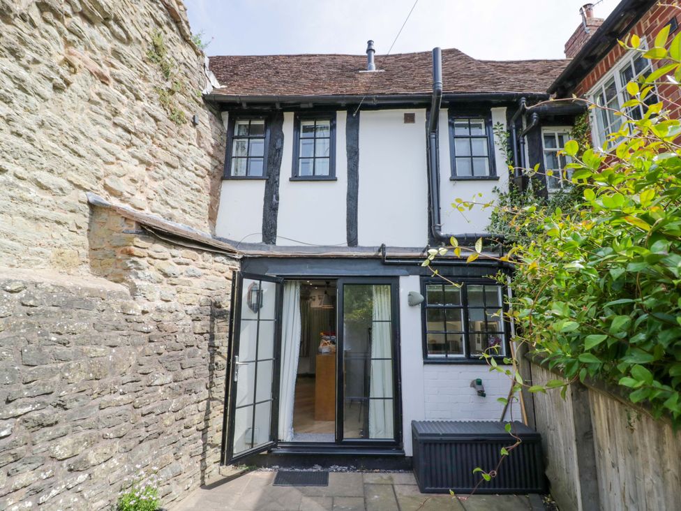 A view of the back of a house with open doors at Middle Cottage in Ludlow
