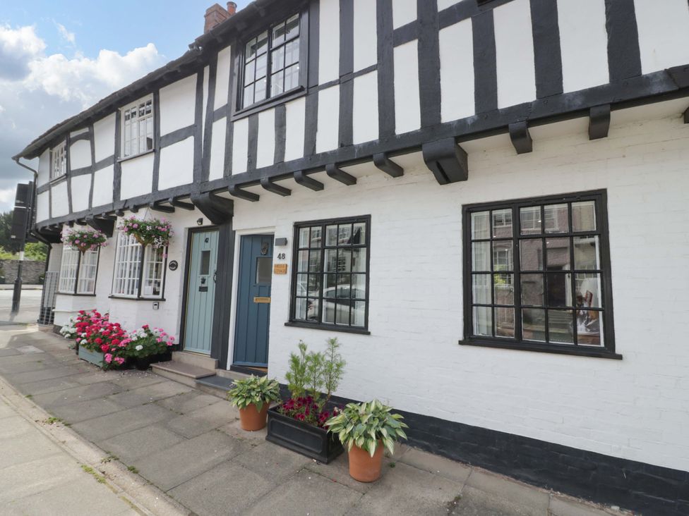 An outdoor view of a building with windows and flower pots at Middle Cottage in Ludlow