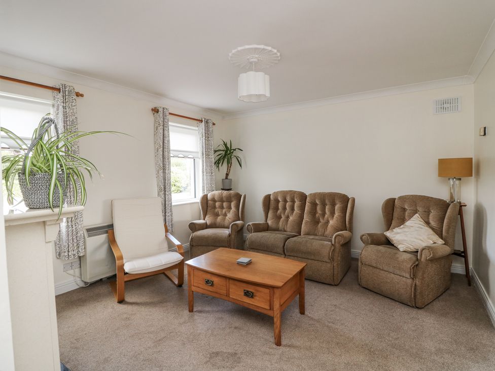 A living room with chairs and a coffee table at Dunbrody Dreams