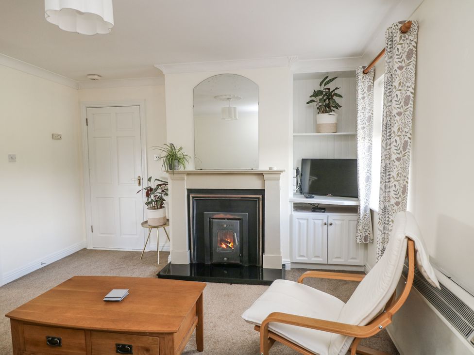 A living room with a fireplace and TV at Dunbrody Dreams