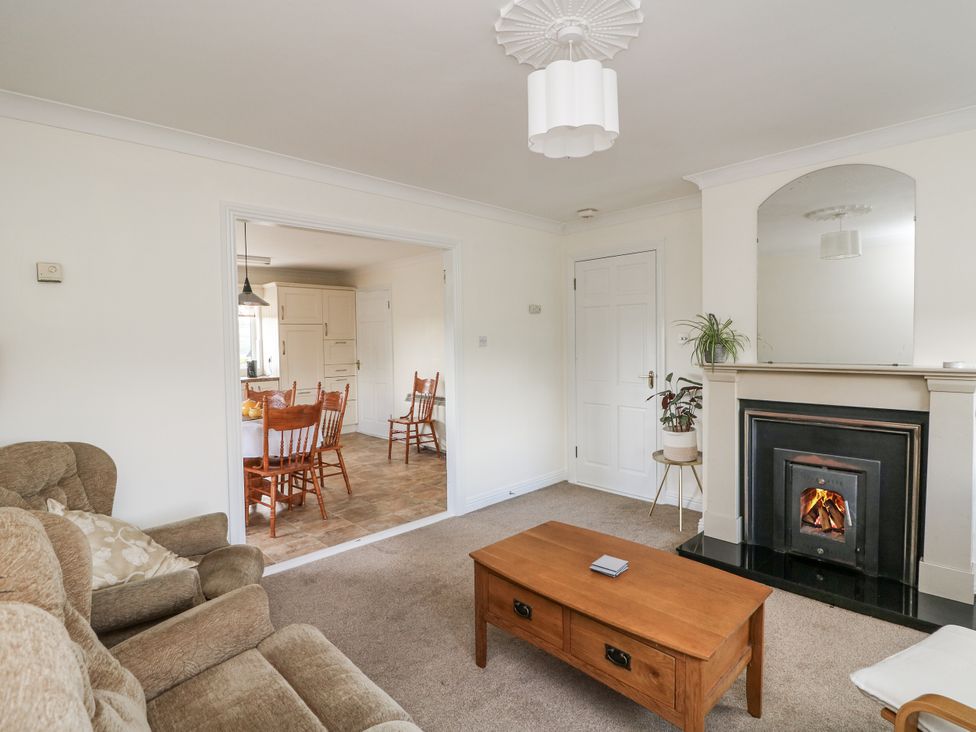 A living room with a sofa, coffee table, and fireplace at Dunbrody Dreams