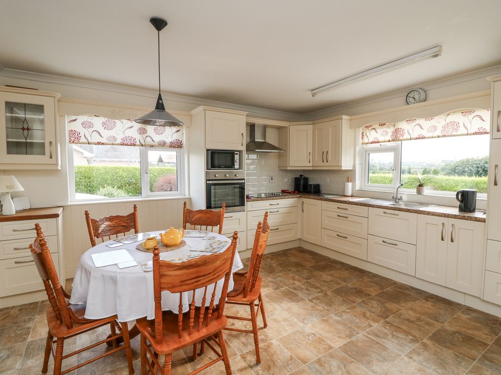 A kitchen with a dining table and chairs at Dunbrody Dreams