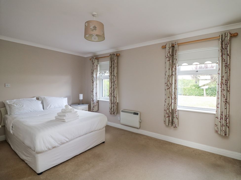 A bedroom with a bed and lamp at Dunbrody Dreams