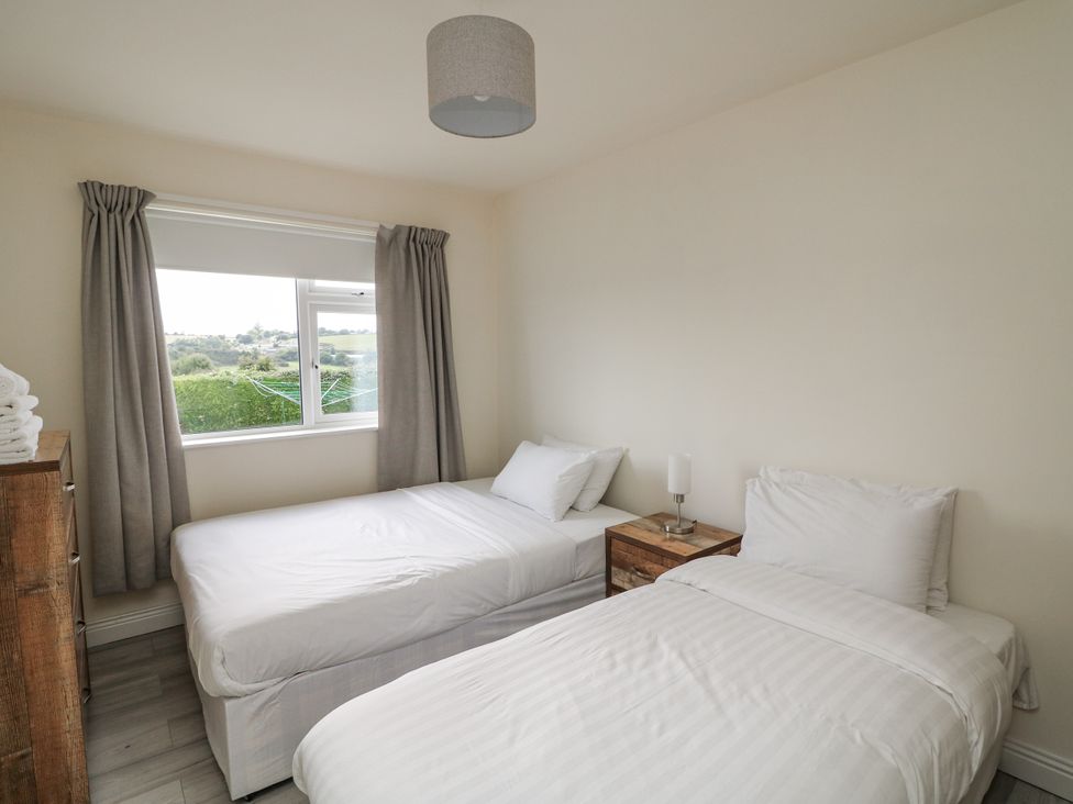 A bedroom with two beds and a nightstand at Dunbrody Dreams