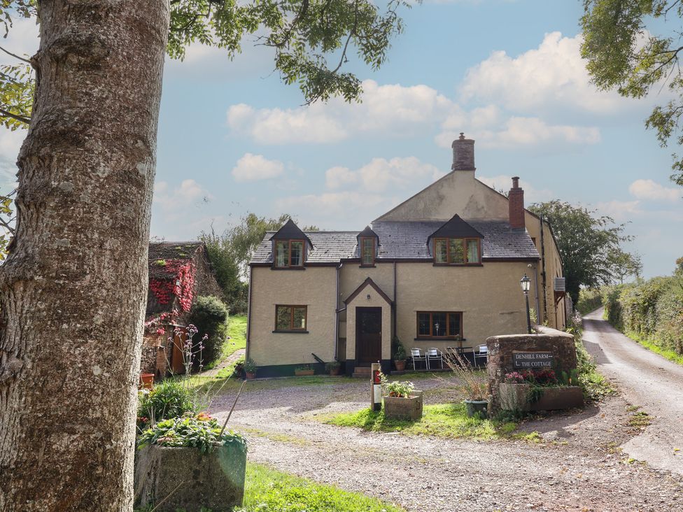 A cottage with a garden and pathway at Denhill Cottage in Chipstable near Wiveliscombe