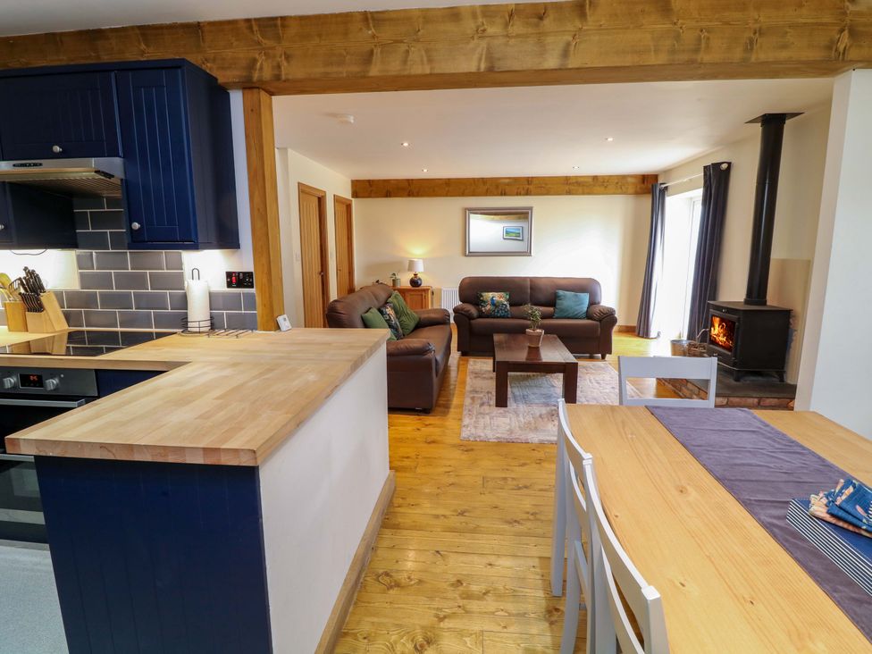 A living room with a sofa and fireplace at Mylo's Cottage in Langrick near Boston