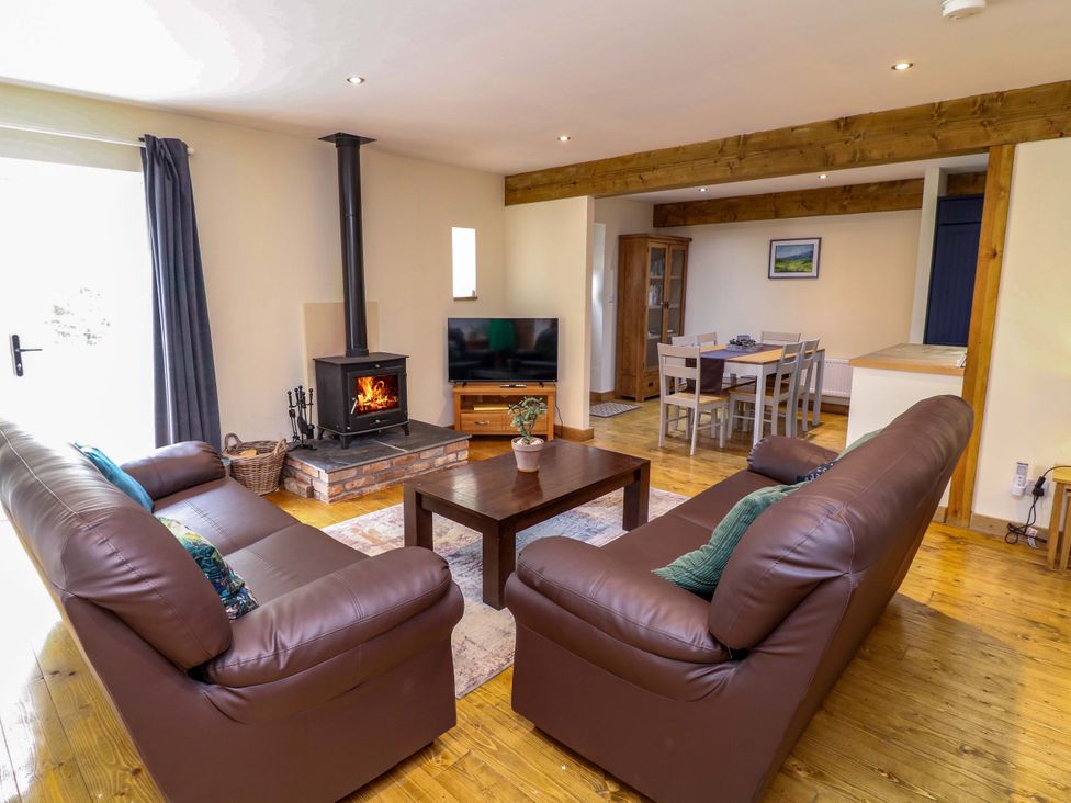 A living room with a fireplace and sofas at Mylo's Cottage in Langrick near Boston
