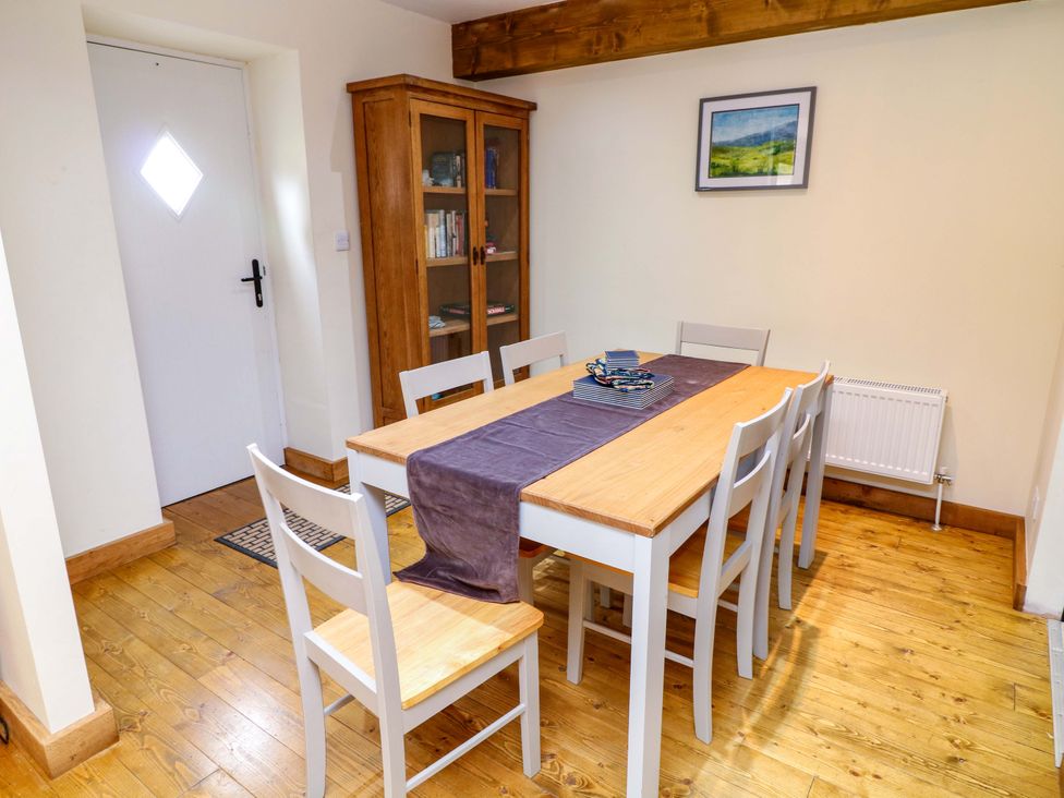 A dining room with a table and chairs at Mylo's Cottage in Langrick near Boston