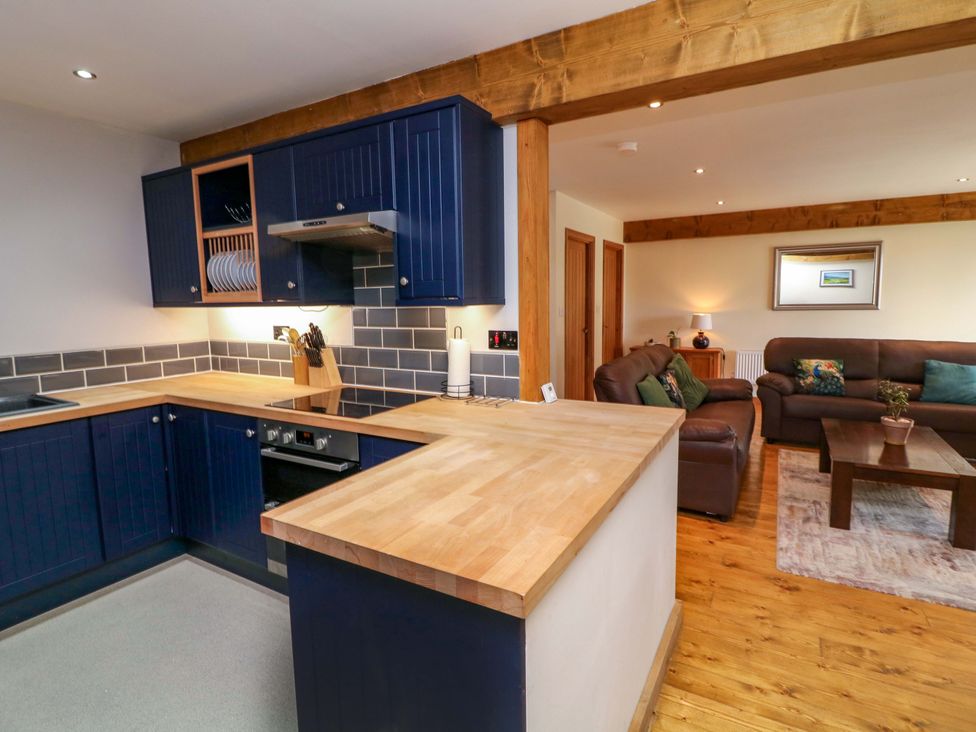 A kitchen with counters and seating at Mylo's Cottage in Langrick near Boston