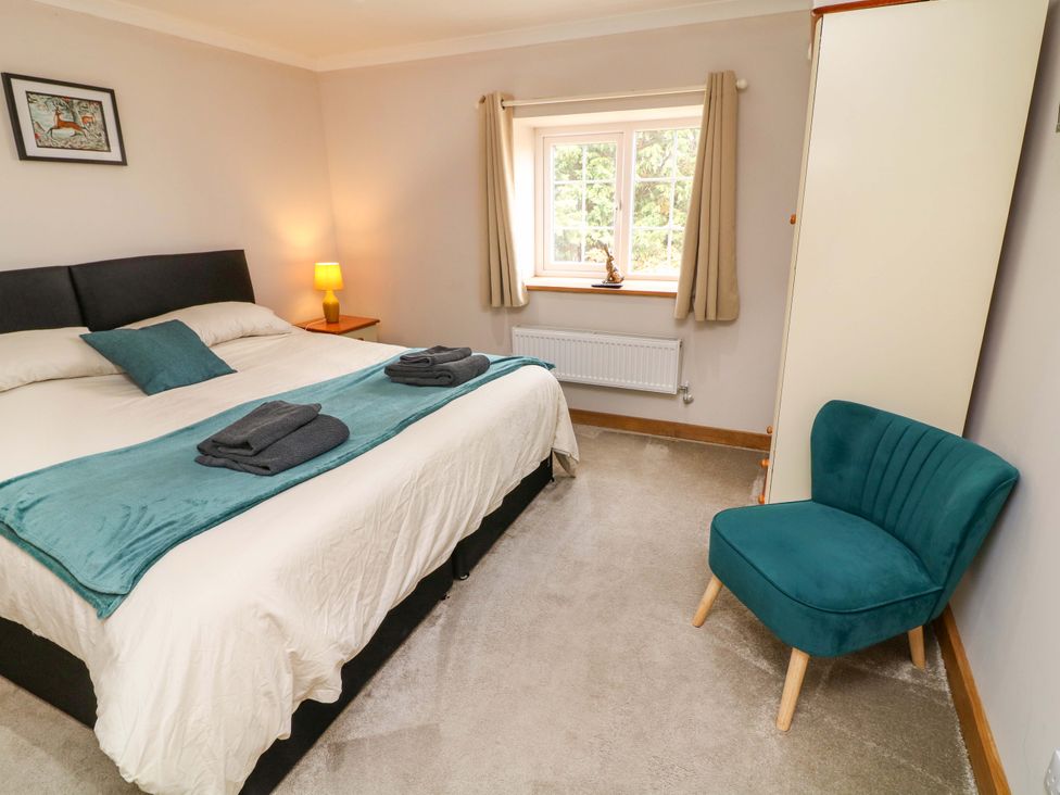 A bedroom with a bed and a window at Mylo's Cottage in Langrick near Boston