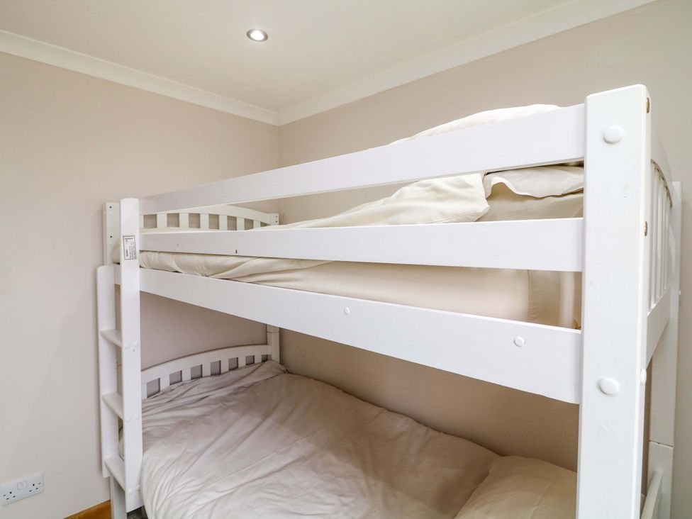A bunk bed with bedding in a bedroom at Mylo's Cottage in Langrick near Boston