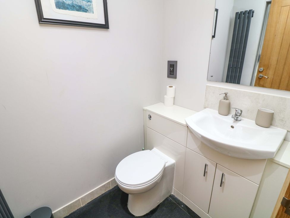 A bathroom with a toilet and sink at Mylo's Cottage in Langrick near Boston