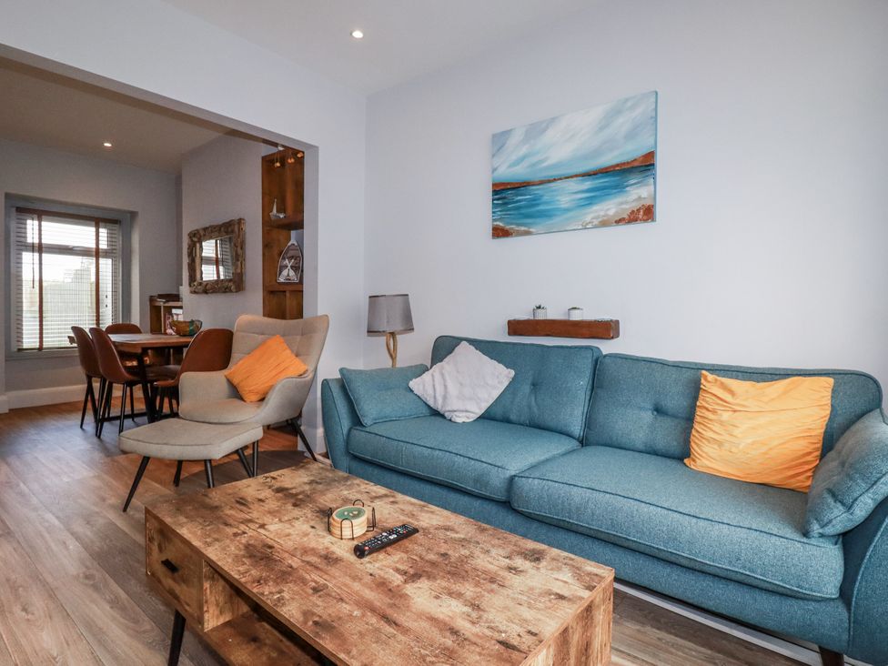 A living room with a sofa and coffee table at Sea Boots in Newquay