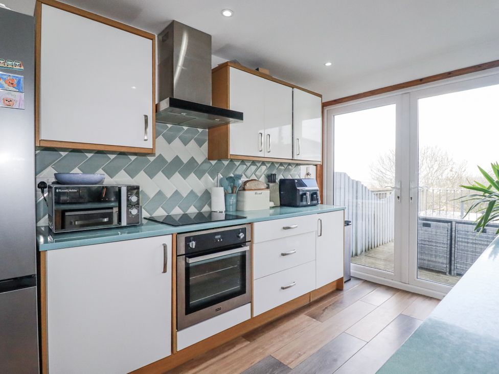 A kitchen with appliances and a view at Sea Boots in Newquay