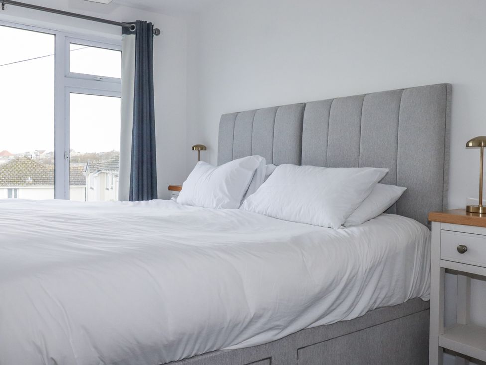 A bedroom with a bed and window at Sea Boots in Newquay