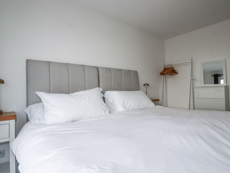 A bedroom with a bed and wardrobe at Sea Boots in Newquay
