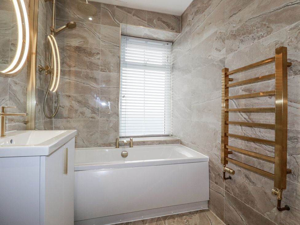 A bathroom with a bathtub, sink, and shower at Sea Boots in Newquay