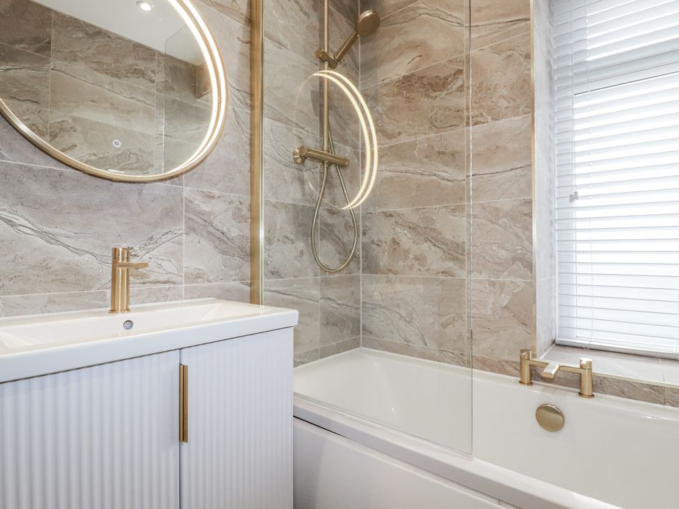 A bathroom with a sink and bath tub at Sea Boots in Newquay