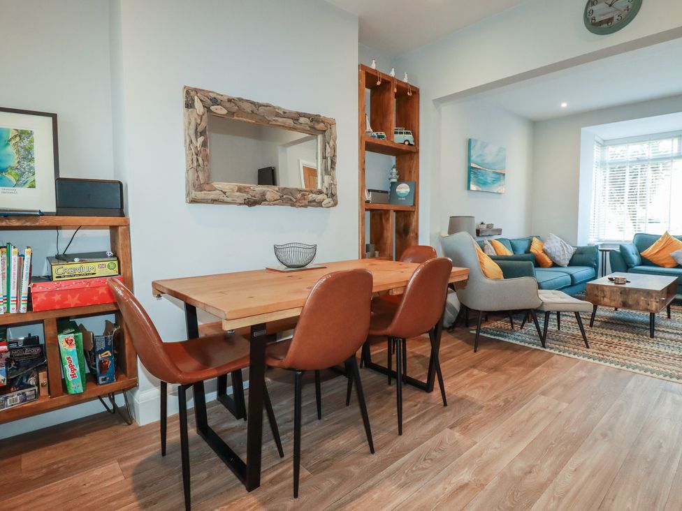 A dining room with a wooden table and chairs at Sea Boots in Newquay