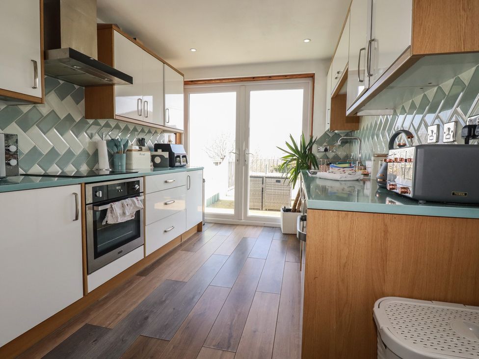 A kitchen with cabinets and appliances at Sea Boots in Newquay