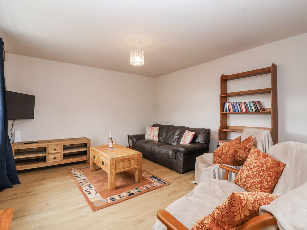 A living room with a sofa and coffee table at The Miners Cottage in Wells