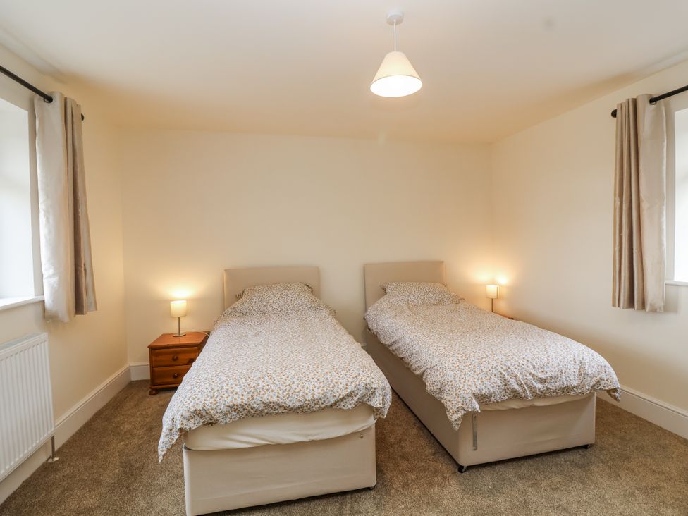 A bedroom with two single beds at The Miners Cottage in Wells