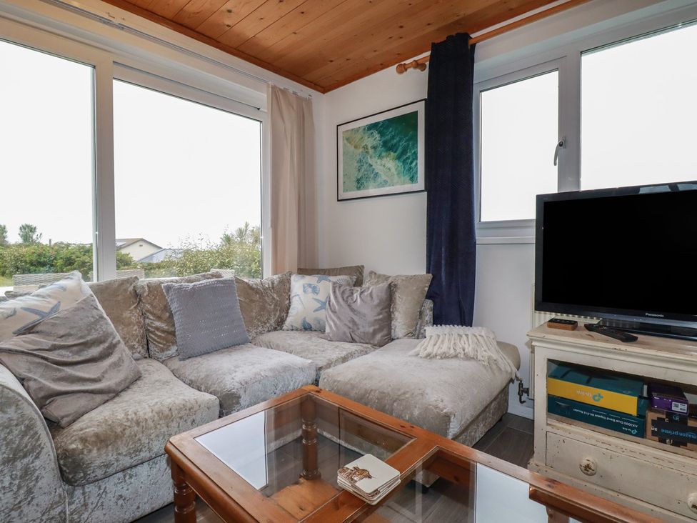 A living room with a sofa and television at 38 Surf View in Newquay