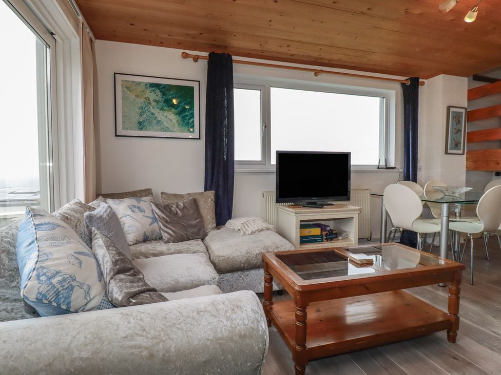 A living room with a sofa and television at 38 Surf View in Newquay