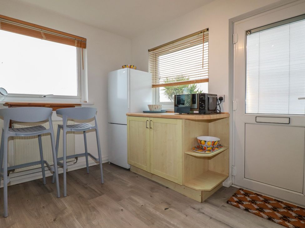 A kitchen with a refrigerator and microwave at 38 Surf View in Newquay