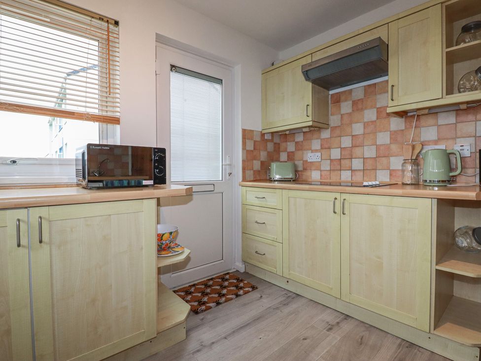 A kitchen with a microwave and kettle at 38 Surf View in Newquay
