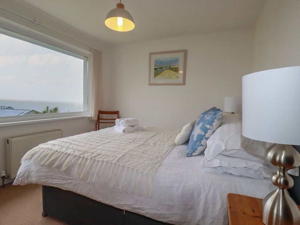 A bedroom with a bed and lamp at 38 Surf View in Newquay