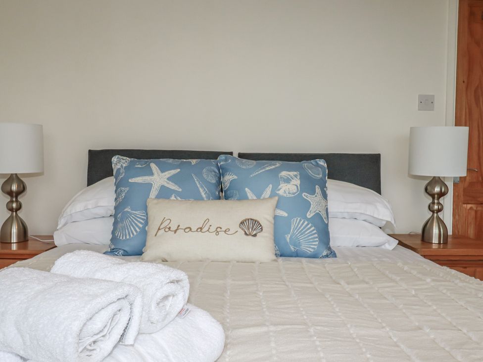 A bedroom with a bed and pillows at 38 Surf View in Newquay