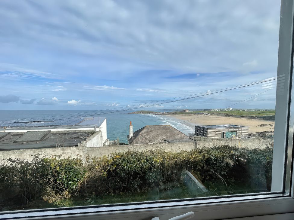 A view of the ocean and beach from inside a property at Surf View in Newquay