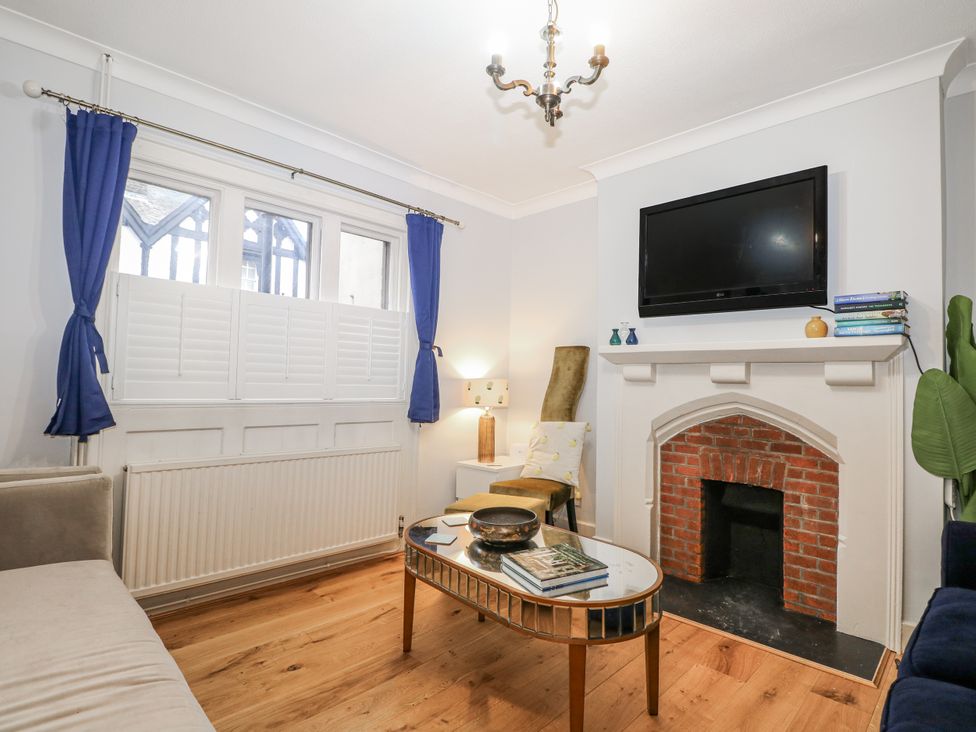 A living room with a sofa and a television at The Old School House in Windsor