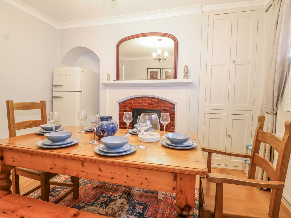 A dining room with a table set for a meal at The Old School House in Windsor