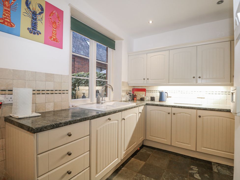 A kitchen with cupboards and a sink at The Old School House in Windsor