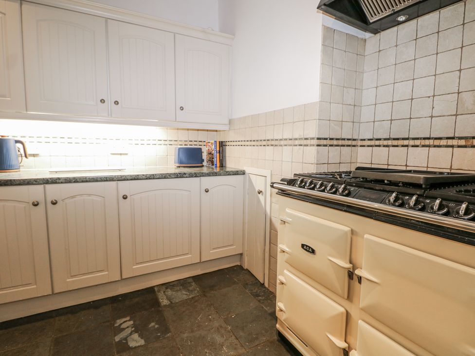 A kitchen with cabinets and a stove at The Old School House in Windsor