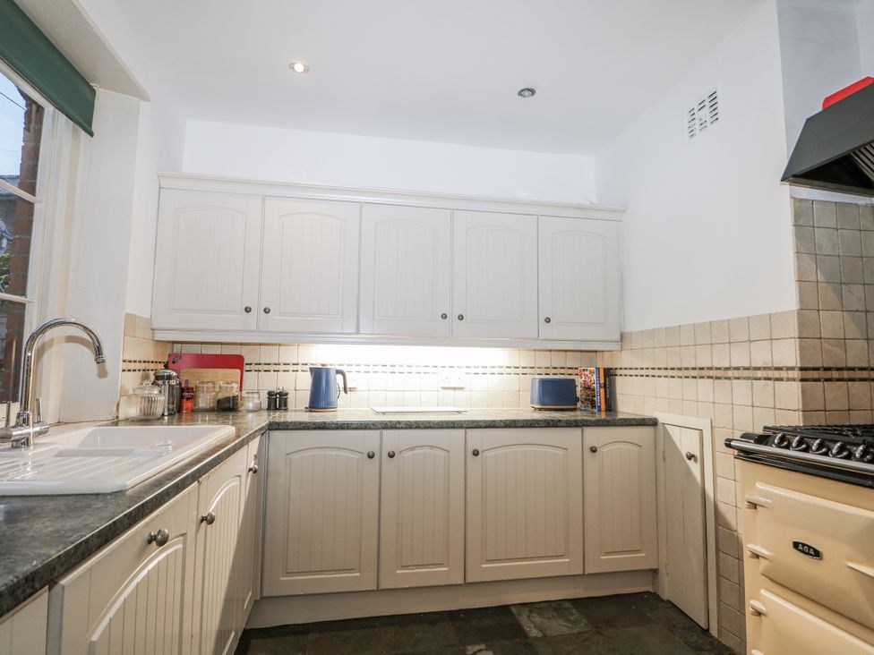 A kitchen with cabinets and a sink at The Old School House in Windsor