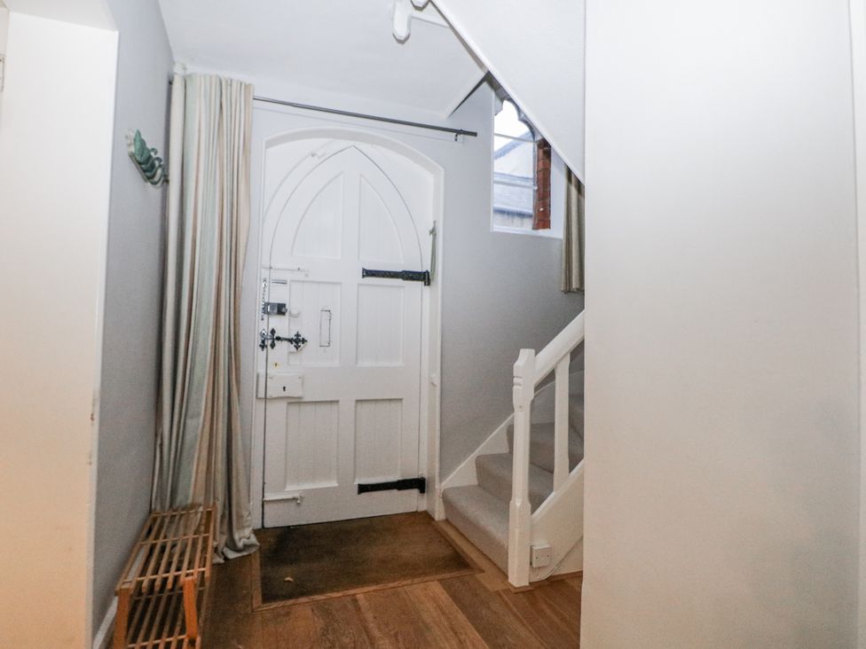 A hallway with a front door and staircase at The Old School House in Windsor