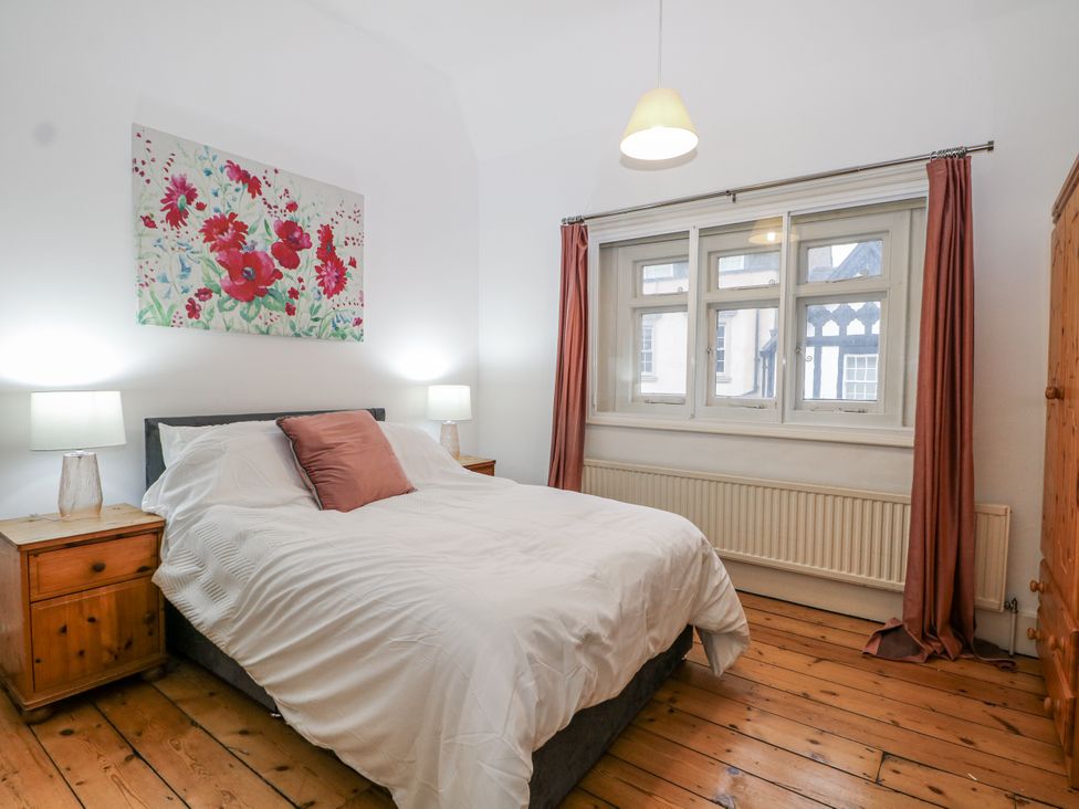 A bedroom with a bed and bedside tables at The Old School House in Windsor