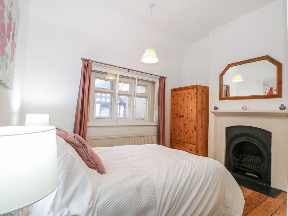 A bedroom with a bed and wardrobe at The Old School House in Windsor
