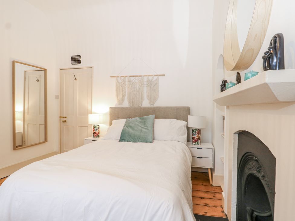 A bedroom with a bed and mirror at The Old School House in Windsor