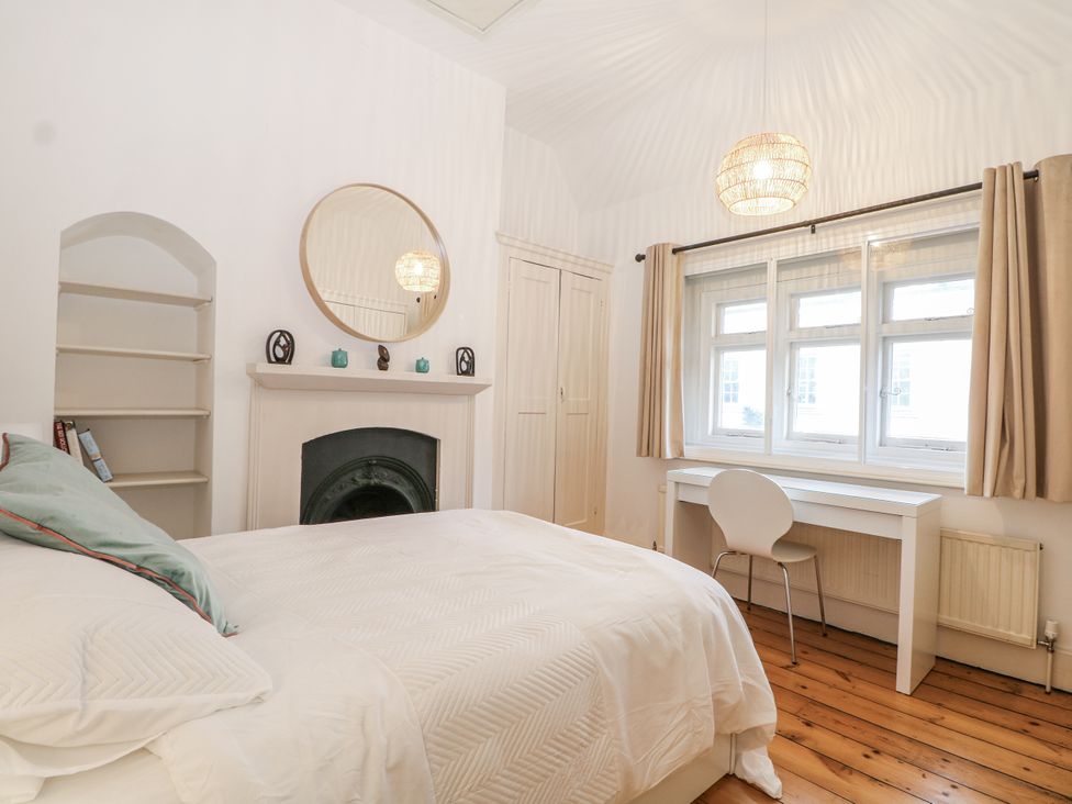 A bedroom with a bed and desk at The Old School House in Windsor